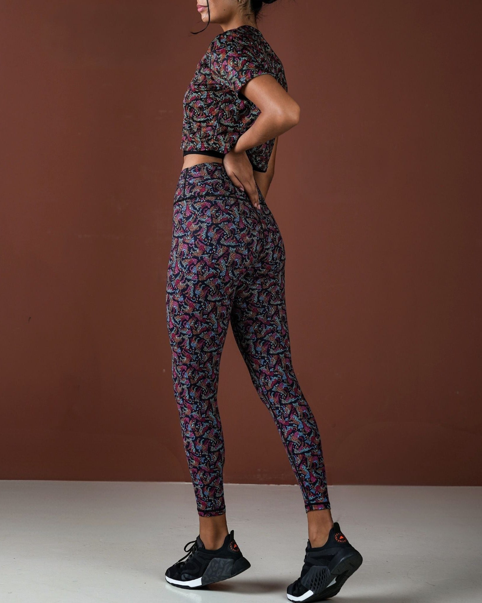 Person wearing a patterned athletic outfit on a brown background