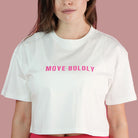 Person wearing a white crop top with 'MOVE BOLDLY' text on a pink background
