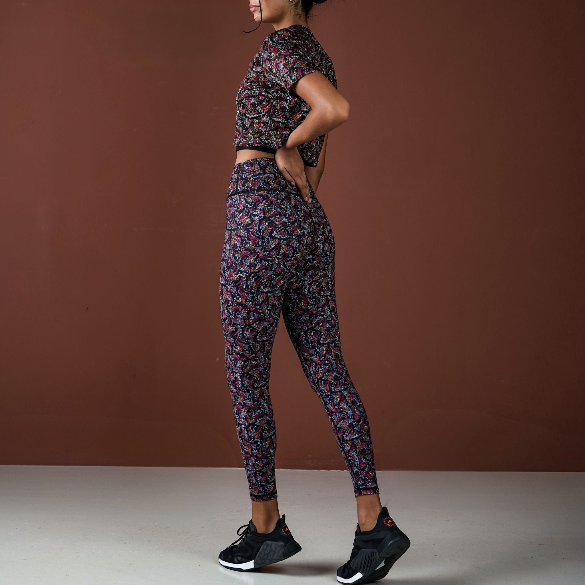 Person wearing a patterned athletic outfit on a brown background